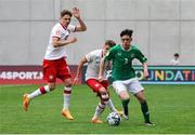 17 May 2023; Cory O'Sullivan of Republic of Ireland in action against Oskar Tomczyk of Poland, left, and Karol Borys during the UEFA European U17 Championship Final Tournament match between Republic of Ireland and Poland at Hidegkuti Nándor Stadion in Budapest, Hungary. Photo by Laszlo Szirtesi/Sportsfile