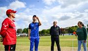 18 May 2023; Leinster Lightning captain George Dockrell makes the coin toss, watched by, from left, Munster Reds captain PJ Moor, Third Umpire Steve Wood and HBV commentator Isobel Joyce, before the Rario Inter-Provincial Cup match between Leinster Lightning and Munster Reds at Pembroke Cricket Club in Dublin. Photo by Tyler Miller/Sportsfile