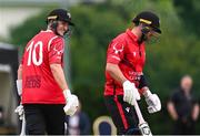 18 May 2023; PJ Moor of Munster Reds celebrates after teammate Tyrone Kane, right, scores a six during the Rario Inter-Provincial Cup match between Leinster Lightning and Munster Reds at Pembroke Cricket Club in Dublin. Photo by Tyler Miller/Sportsfile