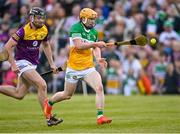 17 May 2023; Cormac Egan of Offaly passes the ball to teammate Adam Screeney, not pictured, in the build up to their side's first goal, as Eoin Whelan of Wexford closes in, during the oneills.com Leinster GAA Hurling U20 Championship Final match between Offaly and Wexford at Netwatch Cullen Park in Carlow. Photo by Piaras Ó Mídheach/Sportsfile