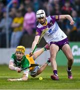 17 May 2023; Dan Bourke of Offaly is tackled by Wexford goalkeeper Derry Mahon during the oneills.com Leinster GAA Hurling U20 Championship Final match between Offaly and Wexford at Netwatch Cullen Park in Carlow. Photo by Piaras Ó Mídheach/Sportsfile