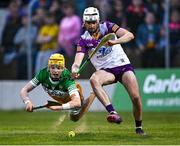 17 May 2023; Dan Bourke of Offaly is tackled by Wexford goalkeeper Derry Mahon during the oneills.com Leinster GAA Hurling U20 Championship Final match between Offaly and Wexford at Netwatch Cullen Park in Carlow. Photo by Piaras Ó Mídheach/Sportsfile