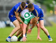 20 May 2023; Oisin Gallen of Donegal is tackled by Cillian Brennan, left, and Eoin Cleary of Clare during the GAA Football All-Ireland Senior Championship Round 1 match between Clare and Donegal at Cusack Park in Ennis, Clare. Photo by Ray McManus/Sportsfile