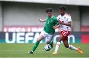 20 May 2023; Cory O'Sullivan of Republic of Ireland in action against Frederick Issaka of Wales during the UEFA European U17 Championship Final Tournament match between Republic of Ireland and Wales at Pancho Aréna in Felcsút, Hungary. Photo by David Balogh/Sportsfile