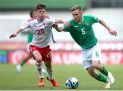 20 May 2023; Daniel Negry-McGrath of Republic of Ireland in action against Troy Perrett of Wales during the UEFA European U17 Championship Final Tournament match between Republic of Ireland and Wales at Pancho Aréna in Felcsút, Hungary. Photo by David Balogh/Sportsfile