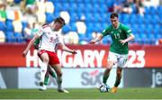 20 May 2023; Mason Melia of Republic of Ireland in action against Dylan Lawlor of Wales during the UEFA European U17 Championship Final Tournament match between Republic of Ireland and Wales at Pancho Aréna in Felcsút, Hungary. Photo by David Balogh/Sportsfile