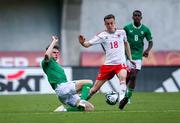 20 May 2023; Alfie Tuck of Wales in action against Luke Kehir of Republic of Ireland during the UEFA European U17 Championship Final Tournament match between Republic of Ireland and Wales at Pancho Aréna in Felcsút, Hungary. Photo by David Balogh/Sportsfile