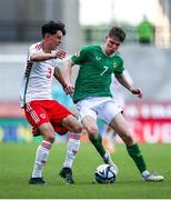 20 May 2023; Luke Kehir of Republic of Ireland in action against Luey Giles of Wales during the UEFA European U17 Championship Final Tournament match between Republic of Ireland and Wales at Pancho Aréna in Felcsút, Hungary. Photo by David Balogh/Sportsfile