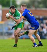20 May 2023; Caolan McGonagle of Donegal in action against Pearse Lillis of Clare during the GAA Football All-Ireland Senior Championship Round 1 match between Clare and Donegal at Cusack Park in Ennis, Clare. Photo by Ray McManus/Sportsfile