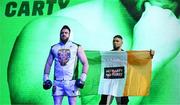 20 May 2023; Thomas Carty is walked to the ring by UFC figher Johnny Walker for his vacant Boxing Union of Ireland celtic heavyweight title fight with Jay McFarlane at the 3Arena in Dublin. Photo by Stephen McCarthy/Sportsfile