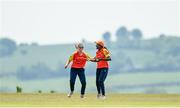 21 May 2023; Mary-Anne Musonda of Scorchers, right, is congratulated by teammate Niamh MacNulty after claiming the wicket of Typhoons batter Georgia Atkinson during the Evoke Super Series match between Typhoons and Scorchers at Oak Hill Cricket Club in Kilbride, Wicklow. Photo by Seb Daly/Sportsfile