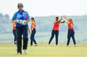 21 May 2023; Mary-Anne Musonda of Scorchers, second from right, is congratulated by teammate Siúin Woods after claiming the wicket of Typhoons batter Georgia Atkinson during the Evoke Super Series match between Typhoons and Scorchers at Oak Hill Cricket Club in Kilbride, Wicklow. Photo by Seb Daly/Sportsfile