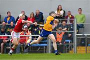 21 May 2023; Tony Kelly of Clare is tackled by Tommy O'Connell of Cork as he scores a first half point during the Munster GAA Hurling Senior Championship Round 4 match between Clare and Cork at Cusack Park in Ennis, Clare. Photo by Ray McManus/Sportsfile