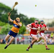21 May 2023; David Fitzgerald of Clare is tackled by Brian Roche of Cork during the Munster GAA Hurling Senior Championship Round 4 match between Clare and Cork at Cusack Park in Ennis, Clare. Photo by Ray McManus/Sportsfile