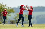 21 May 2023; Jess Mayes of Dragons, left, is congratulated by teammate Cara Murray after claiming the wicket of Typhoons' Robyn Searle during the Evoke Super Series match between Dragons and Typhoons at Oak Hill Cricket Club in Kilbride, Wicklow. Photo by Seb Daly/Sportsfile