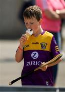 21 May 2023; Wexford supporter Joe Walsh, aged 10, from Enniscorthy, Co Wexford, enjoys an ice-cream ahead of the Leinster GAA Hurling Senior Championship Round 4 match between Wexford and Westmeath at Chadwicks Wexford Park in Wexford. Photo by Daire Brennan/Sportsfile