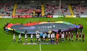 20 May 2023; Players and officials shake hands, as volunteers hold the LGBT Ireland centre circle banner, before the SSE Airtricity Women's Premier Division match between Bohemians and Athlone Town at Dalymount Park in Dublin. Photo by Seb Daly/Sportsfile