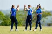 21 May 2023; Typhoons bowler Louise Little, centre, celebrates with teammate Rebecca Gough, left, after claiming the wicket of Dragons batter Bella Armstrong during the Evoke Super Series match between Dragons and Typhoons at Oak Hill Cricket Club in Kilbride, Wicklow. Photo by Seb Daly/Sportsfile