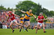 21 May 2023; David Fitzgerald of Clare is tackled by Ciaran Joyce and Brian Roche of Cork during the Munster GAA Hurling Senior Championship Round 4 match between Clare and Cork at Cusack Park in Ennis, Clare. Photo by Ray McManus/Sportsfile