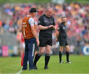 21 May 2023; Referee Johnny Murphy takes a note of Clare's Niall Roamer's name before issuing him with a yellow card during the Munster GAA Hurling Senior Championship Round 4 match between Clare and Cork at Cusack Park in Ennis, Clare. Photo by Ray McManus/Sportsfile