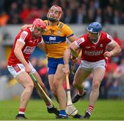 21 May 2023; Peter Duggan of Clare is tackled by Cork players Ciaran Joyce  and Sean O'Donoghue of Cork during the Munster GAA Hurling Senior Championship Round 4 match between Clare and Cork at Cusack Park in Ennis, Clare. Photo by Ray McManus/Sportsfile