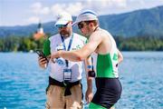 26 May 2023; Brian Colsh of Ireland with Ireland team coach Fran Keane after the Men's Single Sculls Semifinal SC/D during day 2 of the European Rowing Championships 2023 at Bled in Slovenia. Photo by Vid Ponikvar/Sportsfile