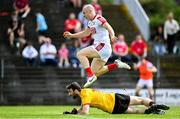 27 May 2023; Brian O'Driscoll of Cork jumps over Louth goalkeeper James Califf after scoring his side's first goal during the GAA Football All-Ireland Senior Championship Round 1 match between Louth and Cork at Páirc Tailteann in Navan, Meath. Photo by Seb Daly/Sportsfile