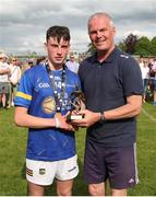 27 May 2023; Cormac Fitzpatrick of Tipperary is presented with the best and fairest award by Ken Hogan after the GAA Celtic Challenge Cup Finals match between Galway and Tipperary at St Brendan’s Park in Birr, Offaly. Photo by Michael P Ryan/Sportsfile