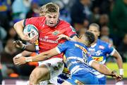 27 May 2023; Jack Crowley of Munster is tackled by Herschel Jantjies of DHL Stormers during the United Rugby Championship Final match between DHL Stormers and Munster at DHL Stadium in Cape Town, South Africa. Photo by Nic Bothma/Sportsfile