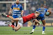 27 May 2023; Manie Libbok of DHL Stormers is tackled by Mike Haley of Munster during the United Rugby Championship Final match between DHL Stormers and Munster at DHL Stadium in Cape Town, South Africa. Photo by Nic Bothma/Sportsfile