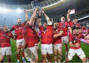 27 May 2023; Munster players, from left, Gavin Coombes, RG Snyman, Roman Salanoa, Jeremy Loughman, Ben Healy, Josh Wycherley and Alex Kendellen celebrate with the trophy after winning the United Rugby Championship Final match between DHL Stormers and Munster at DHL Stadium in Cape Town, South Africa. Photo by Nic Bothma/Sportsfile