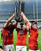 27 May 2023; Munster players, from left, Gavin Coombes, Ben Healy and Alex Kendellen celebrate with the trophy after the United Rugby Championship Final match between DHL Stormers and Munster at DHL Stadium in Cape Town, South Africa. Photo by Ashley Vlotman/Sportsfile