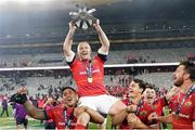 27 May 2023; Keith Earls of Munster is carried by teammates Malakai Fekitoa, left, and Antoine Frisch as they celebrate with the trophy afterthe United Rugby Championship Final match between DHL Stormers and Munster at DHL Stadium in Cape Town, South Africa. Photo by Nic Bothma/Sportsfile