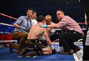 27 May 2023; Michael Conlan receives medical attention after being knocked down by Luis Alberto Lopez during their IBF Featherweight World Title bout at the SSE Arena in Belfast. Photo by Ramsey Cardy/Sportsfile