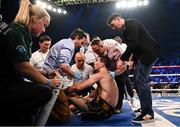 27 May 2023; Michael Conlan is surrounded by medical personnel and his brother Jamie after being knocked down by Luis Alberto Lopez during their IBF Featherweight World Title bout at the SSE Arena in Belfast. Photo by Ramsey Cardy/Sportsfile