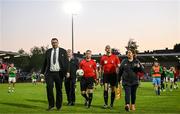 26 May 2023; Referee Sean Grant is escorted from the pitch by Cork City event controller Robbie Kelleher and head of security Carol O'Sulivan after the SSE Airtricity Men's Premier Division match between Cork City and Shamrock Rovers at Turner's Cross in Cork. Photo by Eóin Noonan/Sportsfile