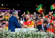 27 May 2023; Paul Doyle of Carlow is presented the cup by Uachtarán Chumann Lúthchleas Gael Larry McCarthy during the Joe McDonagh Cup Final match between Carlow and Offaly at Croke Park in Dublin. Photo by Tyler Miller/Sportsfile