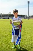 28 May 2023; Monaghan supporter Liam Morton, 9, from Inniskeen Grattans holds the trophy before the Electric Ireland Ulster Minor GAA Football Championship Final match between Derry and Monaghan at Box-It Athletic Grounds in Armagh. Photo by Stephen Marken/Sportsfile