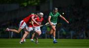 28 May 2023; Gearoid Hegarty of Limerick races clear of Cork players Robert Downey and Patrick Horgan, left, during the Munster GAA Hurling Senior Championship Round 5 match between Limerick and Cork at TUS Gaelic Grounds in Limerick. Photo by Ray McManus/Sportsfile