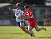 28 May 2023; Johnny McGuckia of Derry in action against Tommy Mallen of Monaghan during the Electric Ireland Ulster Minor GAA Football Championship Final match between Derry and Monaghan at Box-It Athletic Grounds in Armagh. Photo by Stephen Marken/Sportsfile