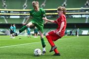 31 May 2023; Patrick Lohan of St Mary’s NS, Mountbellew, Galway, in action against Anthony Cashman of Scoil Naomh Iosef, Dromcollogher, Limerick, during the ‘A’ Cup, for mixed small sized schools, at the FAI Primary School 5s National Finals in the Aviva Stadium, Dublin. Photo by Eóin Noonan/Sportsfile