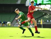 31 May 2023; Richard Christie of St John the Apostle, Knocknacarra, Galway in action against Evan Lonergan of Ballylooby NS, Tipperary, during the ‘B’ Cup, for mixed medium sized schools, at the FAI Primary School 5s National Finals in the Aviva Stadium, Dublin. Photo by Eóin Noonan/Sportsfile