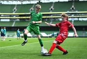 31 May 2023; Patrick Lohan of St Mary’s NS, Mountbellew, Galway, in action against Anthony Cashman of Scoil Naomh Iosef, Dromcollogher, Limerick, during the ‘A’ Cup, for mixed small sized schools, at the FAI Primary School 5s National Finals in the Aviva Stadium, Dublin. Photo by Eóin Noonan/Sportsfile