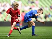 31 May 2023; Tiernan O’Flynn of Scoil Naomh Iosef, Dromcollogher, Limerick, in action against Oisín Wall of St Joseph’s NS, Hacketstown, Carlow, during the ‘A’ Cup, for mixed small sized schools, at the FAI Primary School 5s National Finals in the Aviva Stadium, Dublin. Photo by Eóin Noonan/Sportsfile
