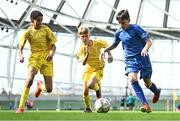 31 May 2023; Stephen Moran of St Kevin’s NS, Greystones, Wicklow, in action against Helder Carvalho, left, and Oran Daly of Scoil Cholmcille, Letterkenny, Donegal, during the ‘C’ Cup, for mixed large sized schools, at the FAI Primary School 5s National Finals in the Aviva Stadium, Dublin. Photo by Eóin Noonan/Sportsfile