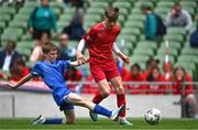 31 May 2023; John Sheahan of Monaleen NS, Limerick, is tackled by Cillian Walsh of St Kevin’s NS, Greystones, Wicklow, during the ‘C’ Cup, for mixed large sized schools, at the FAI Primary School 5s National Finals in the Aviva Stadium, Dublin. Photo by Eóin Noonan/Sportsfile