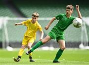 31 May 2023; Cadhan McGonagle of Scoil Naomh Colmcille, Donegal, in action against Ronan McDermott of St Mary’s NS, Mountbellew, Galway, during the ‘A’ Cup, for mixed small sized schools, at the FAI Primary School 5s National Finals in the Aviva Stadium, Dublin. Photo by Eóin Noonan/Sportsfile
