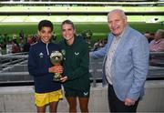 31 May 2023; Sean Gallagher of Scoil Cholmcille, Letterkenny, Donegal, is presented with the ‘C’ Cup, for mixed large sized schools, player of the tournament award by Republic of Ireland's Jamie Finn and FAI President Gerry McAnaney at the FAI Primary School 5s National Finals in the Aviva Stadium, Dublin. Photo by Stephen McCarthy/Sportsfile