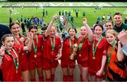 31 May 2023; Gaelscoil Charraig Uí Leighin, Cork, players celebrate with the ‘C’ Girls Cup, for large sized schools, and their supporters during the FAI Primary School 5s National Finals at the Aviva Stadium in Dublin. Photo by Stephen McCarthy/Sportsfile