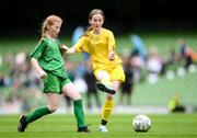 31 May 2023; Erin Logue of Scoil Colmcille, Kerrykeel, Donegal, right, in action against Lillian Fleming of Castleblakeney NS, Galway, during the ‘A’ Girls Cup, for small sized schools, at the FAI Primary School 5s National Finals in the Aviva Stadium, Dublin. Photo by Stephen McCarthy/Sportsfile